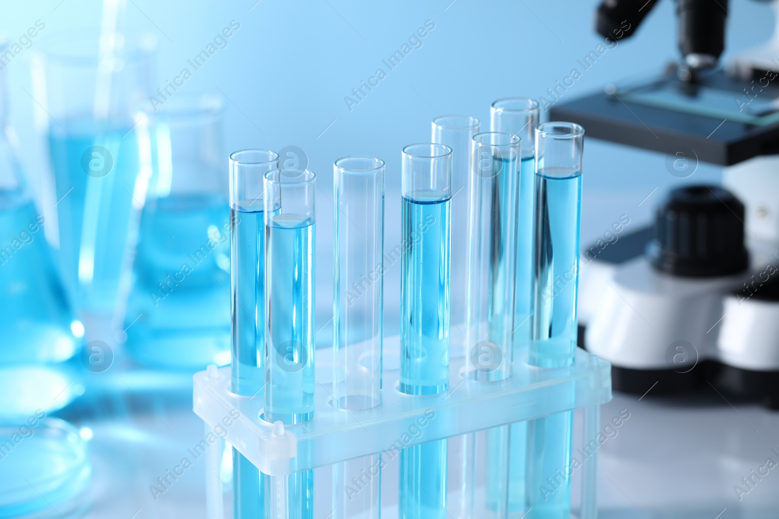 Photo of Test tubes with light blue liquid in laboratory, closeup