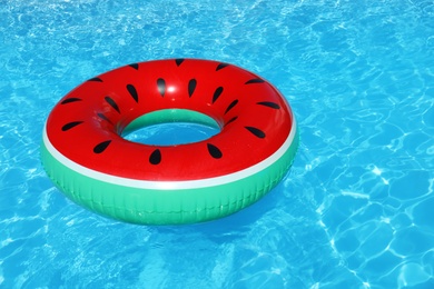 Photo of Inflatable ring floating in swimming pool on sunny day