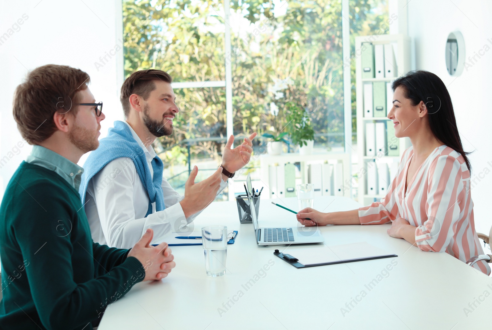 Photo of Human resources manager conducting job interview with applicants in office