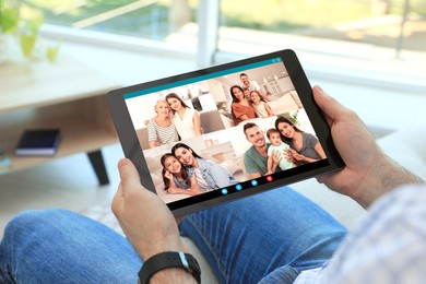 Image of Man having online meeting with family members via videocall application indoors, closeup
