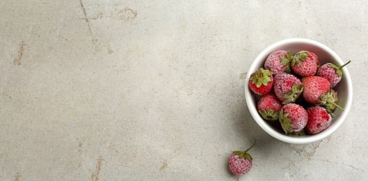 Photo of Tasty frozen strawberries on light table, flat lay. Space for text