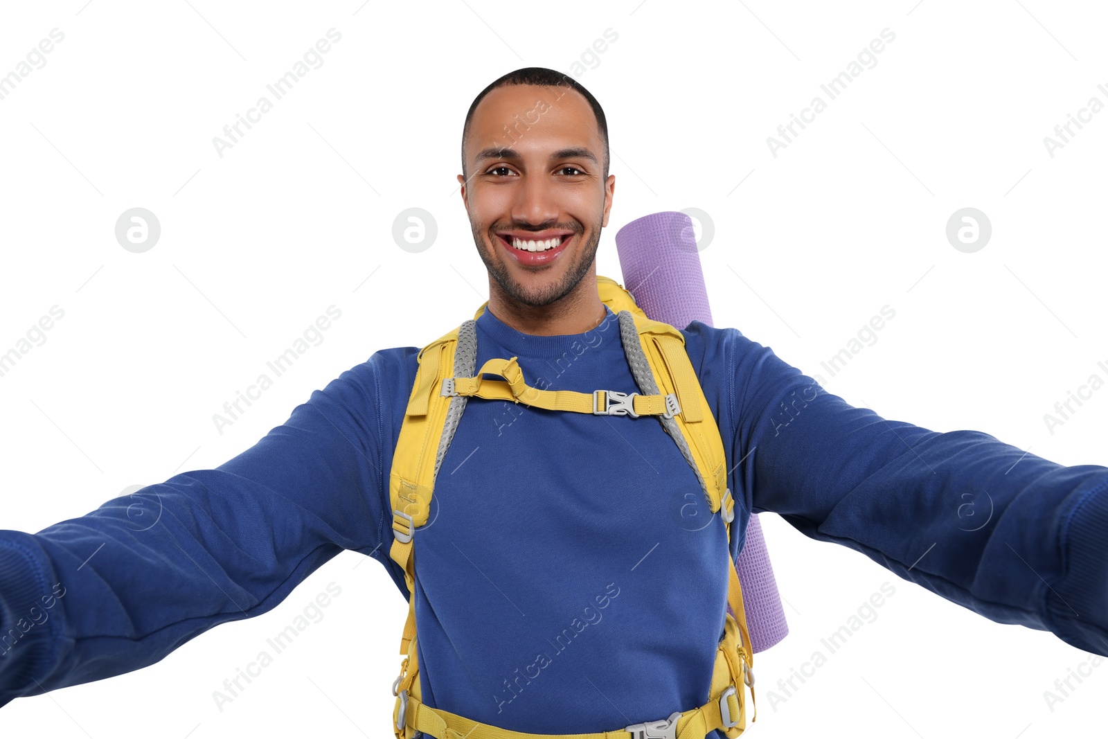 Photo of Happy tourist with backpack taking selfie on white background