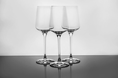 Empty clear wine glasses on white background