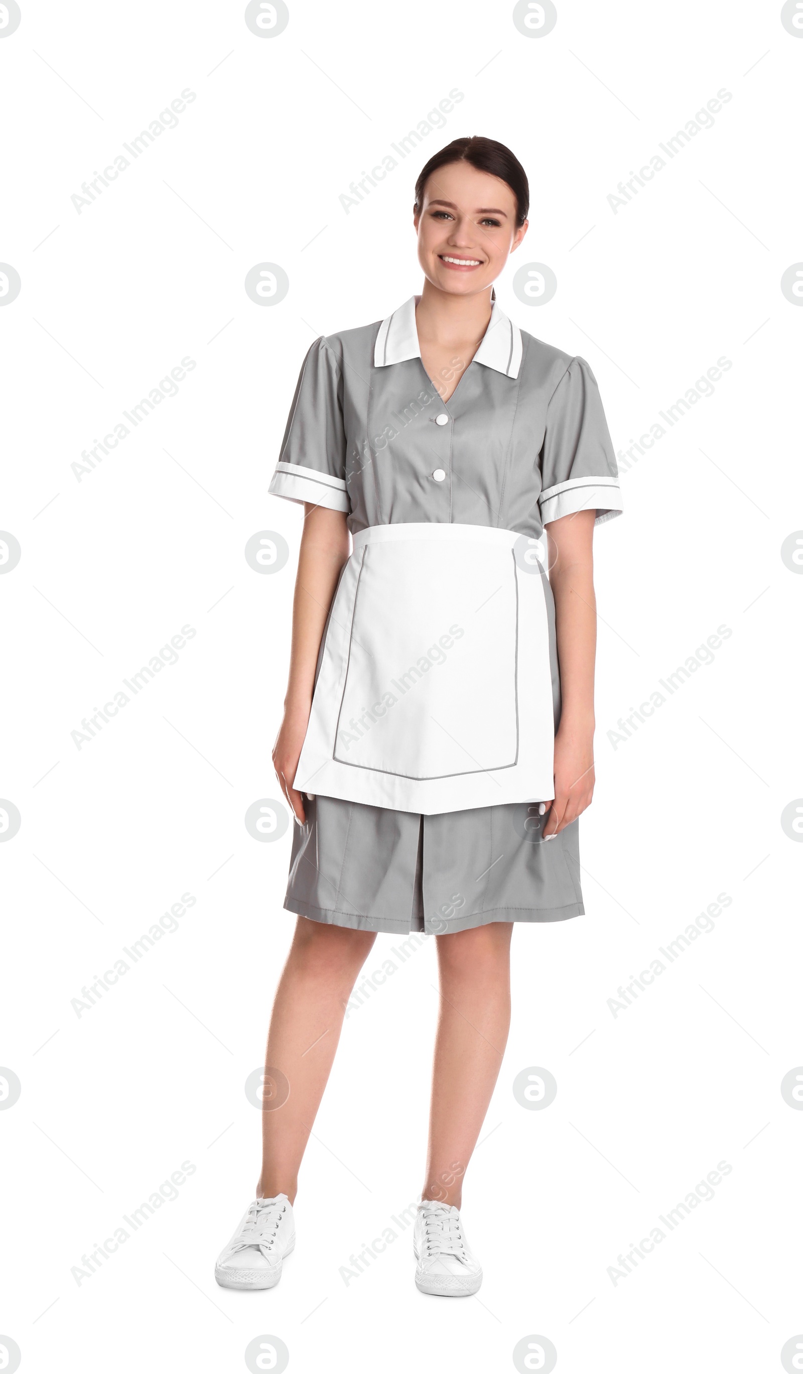 Photo of Young chambermaid in uniform on white background