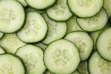 Fresh slices of cucumbers as background, top view