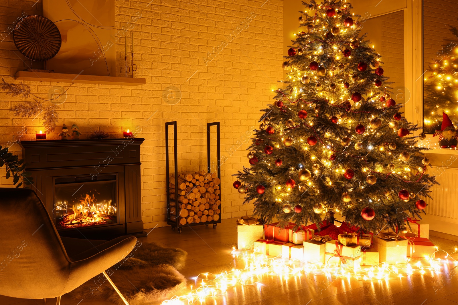 Photo of Beautiful Christmas tree with festive lights near fireplace in room. Interior design