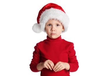 Photo of Cute child in Santa hat on white background. Christmas celebration