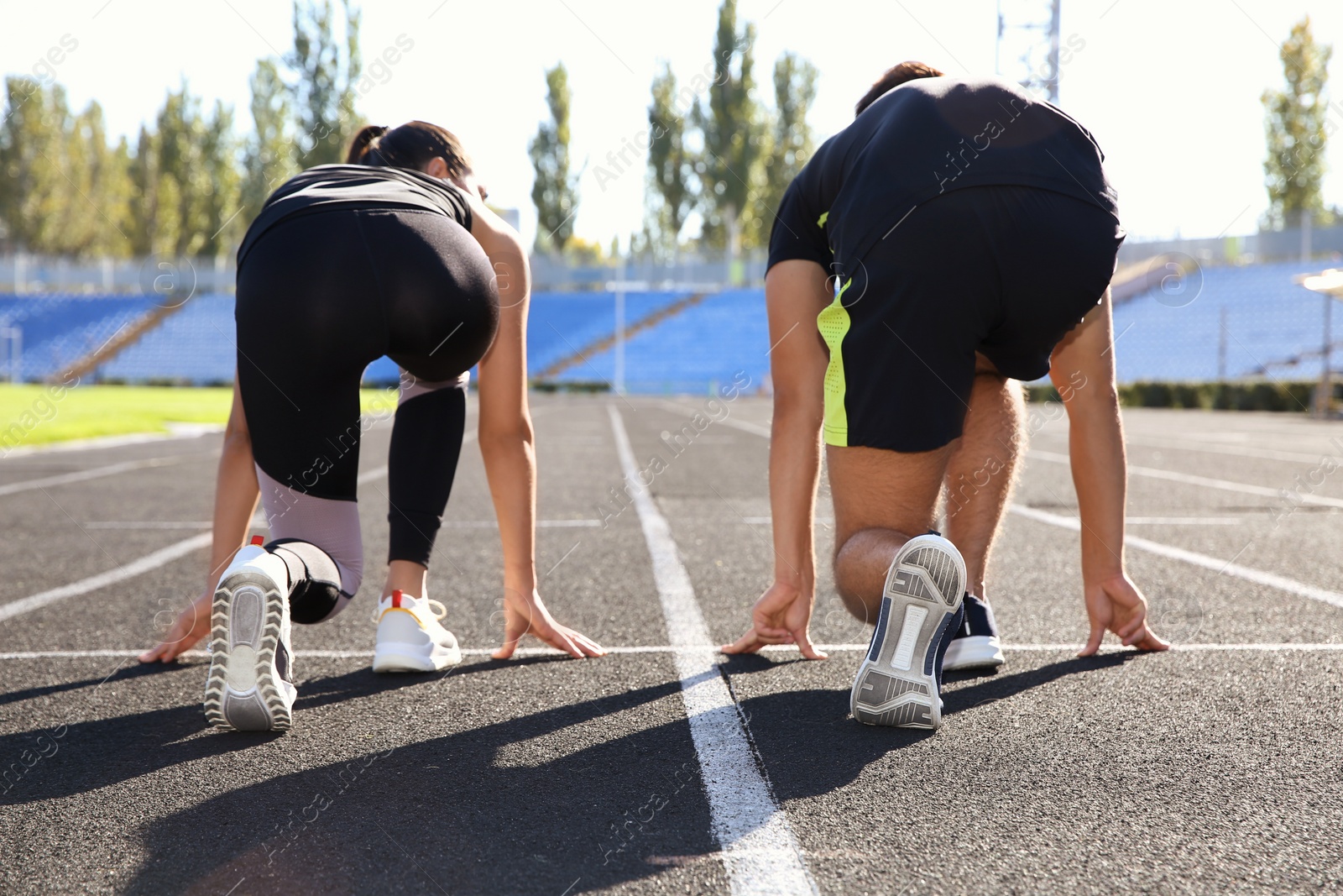 Photo of Sporty couple ready for running at stadium on sunny morning