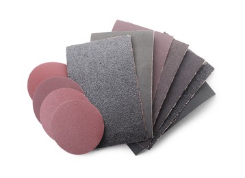 Photo of Many sheets of sandpaper isolated on white, top view