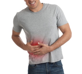 Man suffering from liver pain on white background, closeup