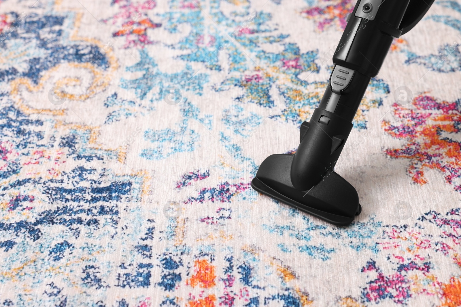 Photo of Hoovering carpet with vacuum cleaner, space for text