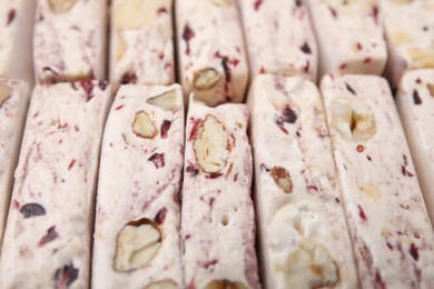 Photo of Pieces of delicious nougat as background, closeup