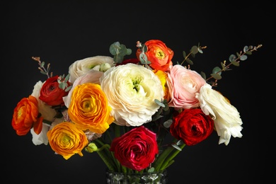 Photo of Bouquet with beautiful bright ranunculus flowers on dark background