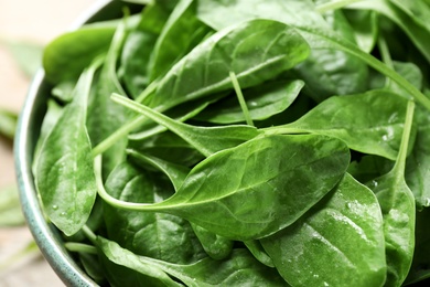 Photo of Fresh green healthy spinach in ceramic bowl, closeup