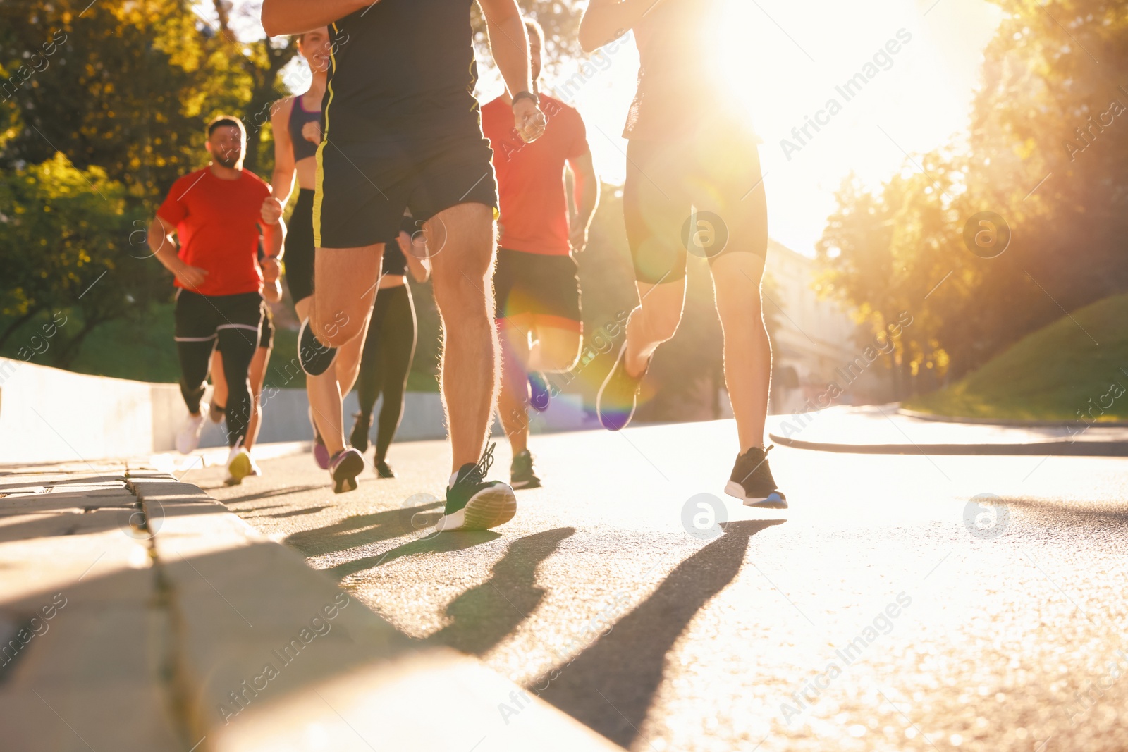 Photo of Group of people running outdoors on sunny day