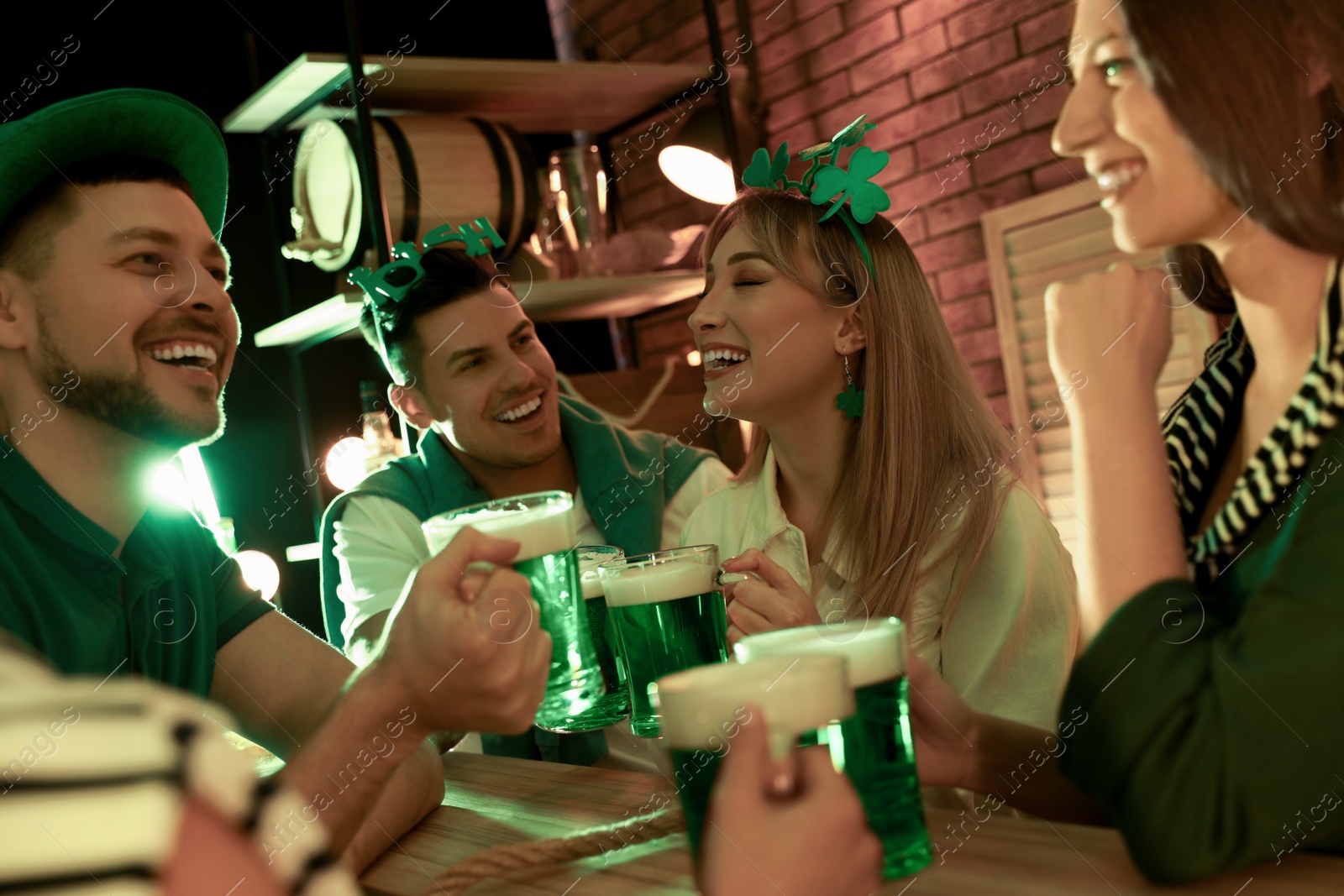 Photo of People with beer celebrating St Patrick's day in pub