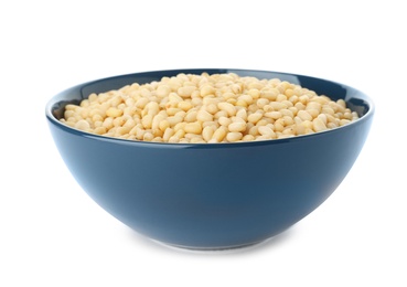 Photo of Bowl with pine nuts on white background