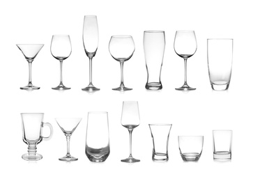 Set of different empty glasses on white background