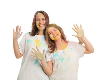 Photo of Woman and girl covered with colorful powder dyes on white background. Holi festival celebration