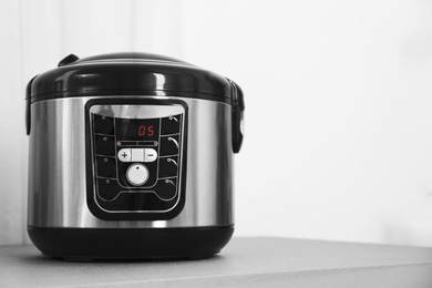 Photo of Modern multi cooker on table. Space for text