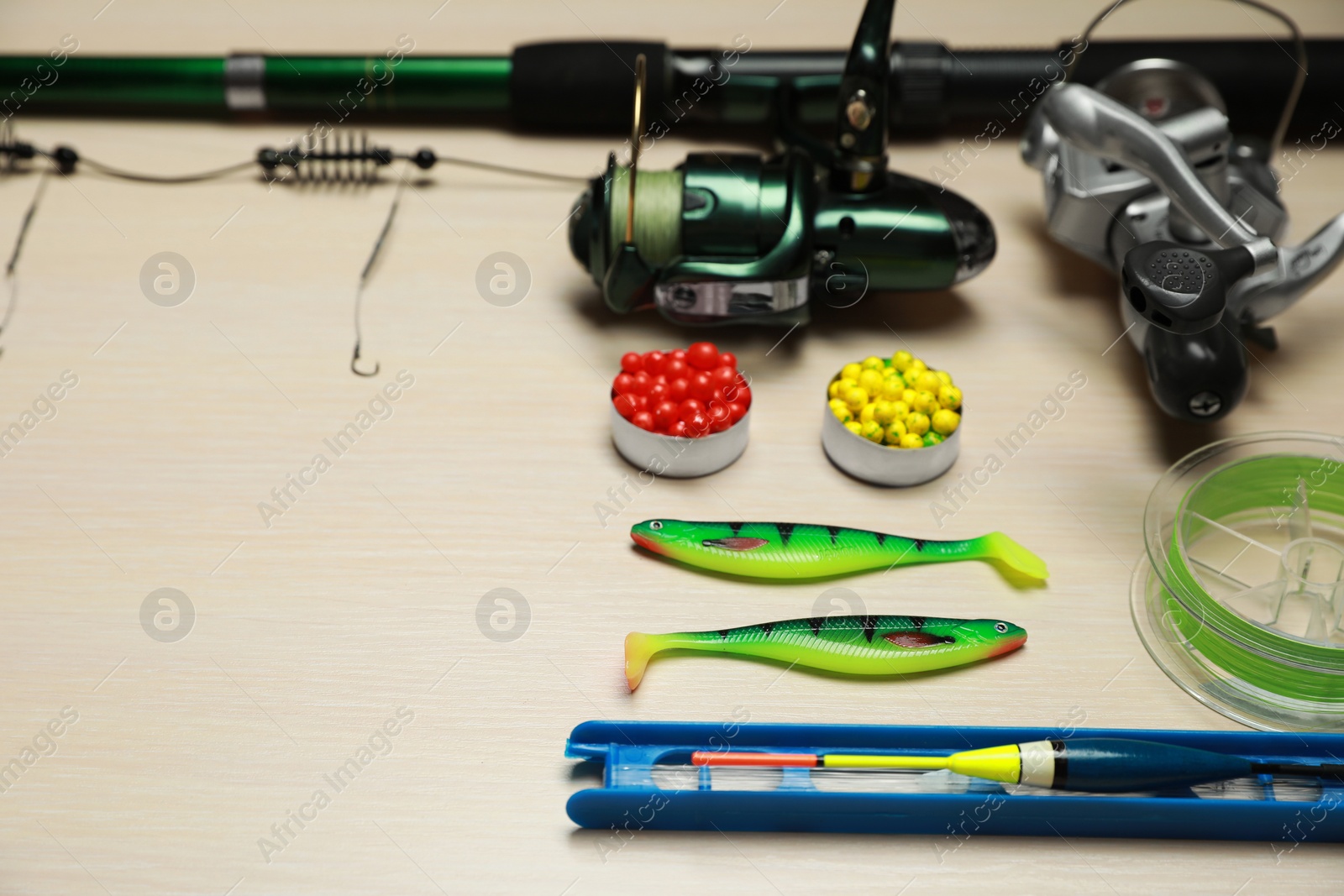 Photo of Fishing tackle on wooden background. Space for text