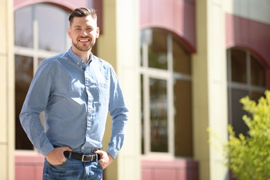 Portrait of young man in stylish outfit outdoors