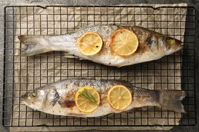 Photo of Baked fish with lemon on cooling rack, top view