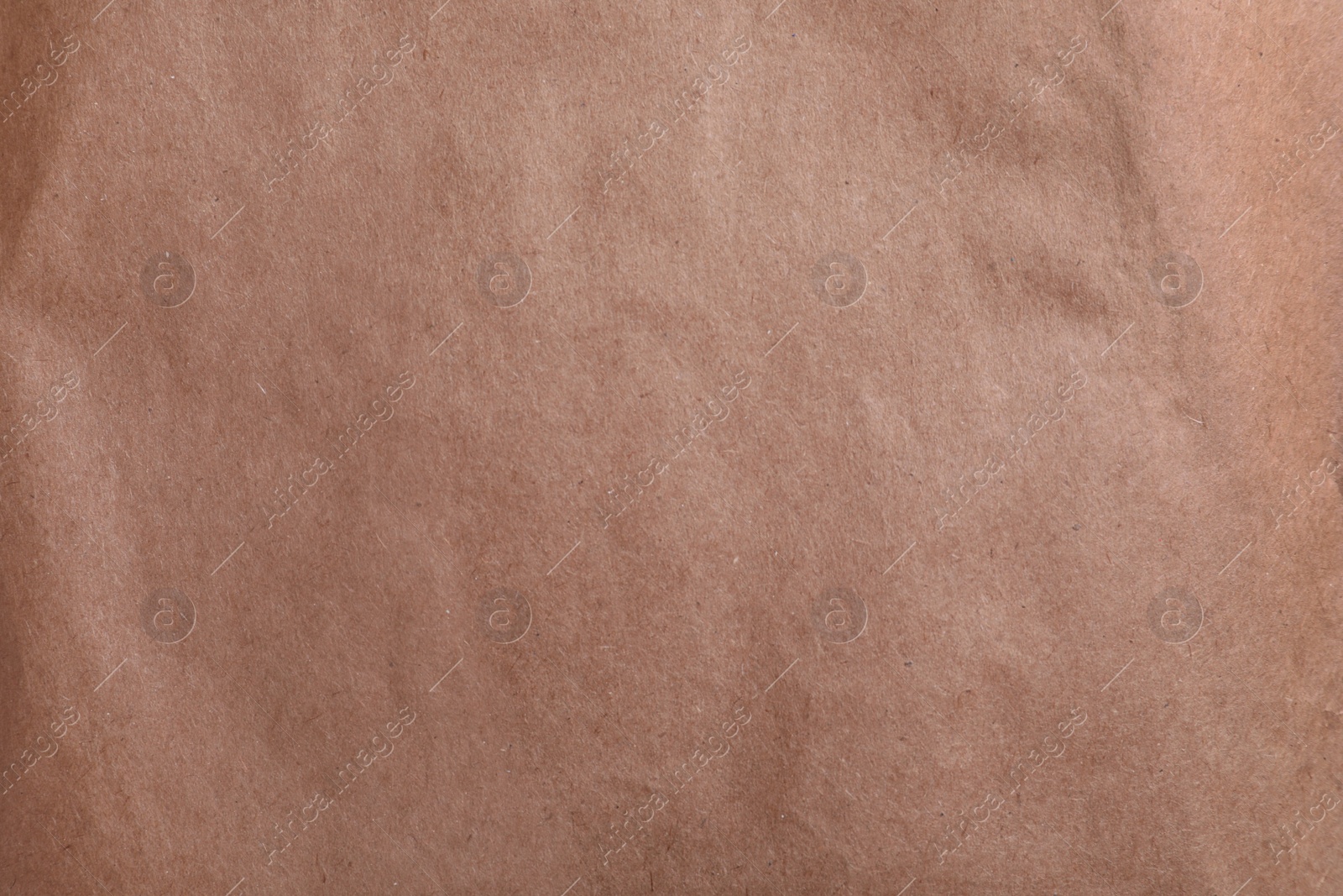 Photo of Texture of kraft paper bag as background, closeup