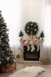 Fireplace in room with Christmas decorations. Interior design