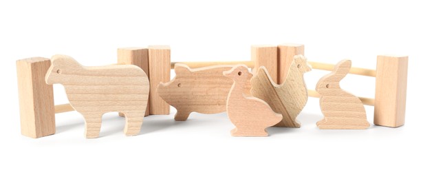Photo of Wooden animals and fence isolated on white. Children's toy