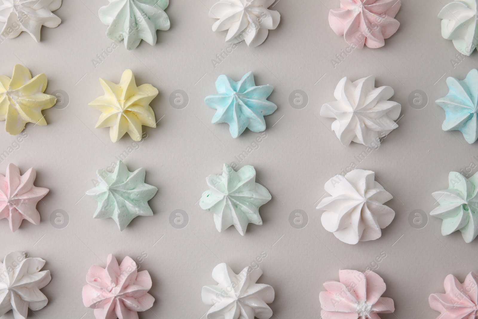 Photo of Delicious meringue cookies on light background, flat lay