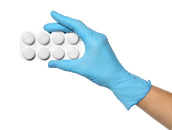 Scientist in protective gloves holding pills on white background, closeup