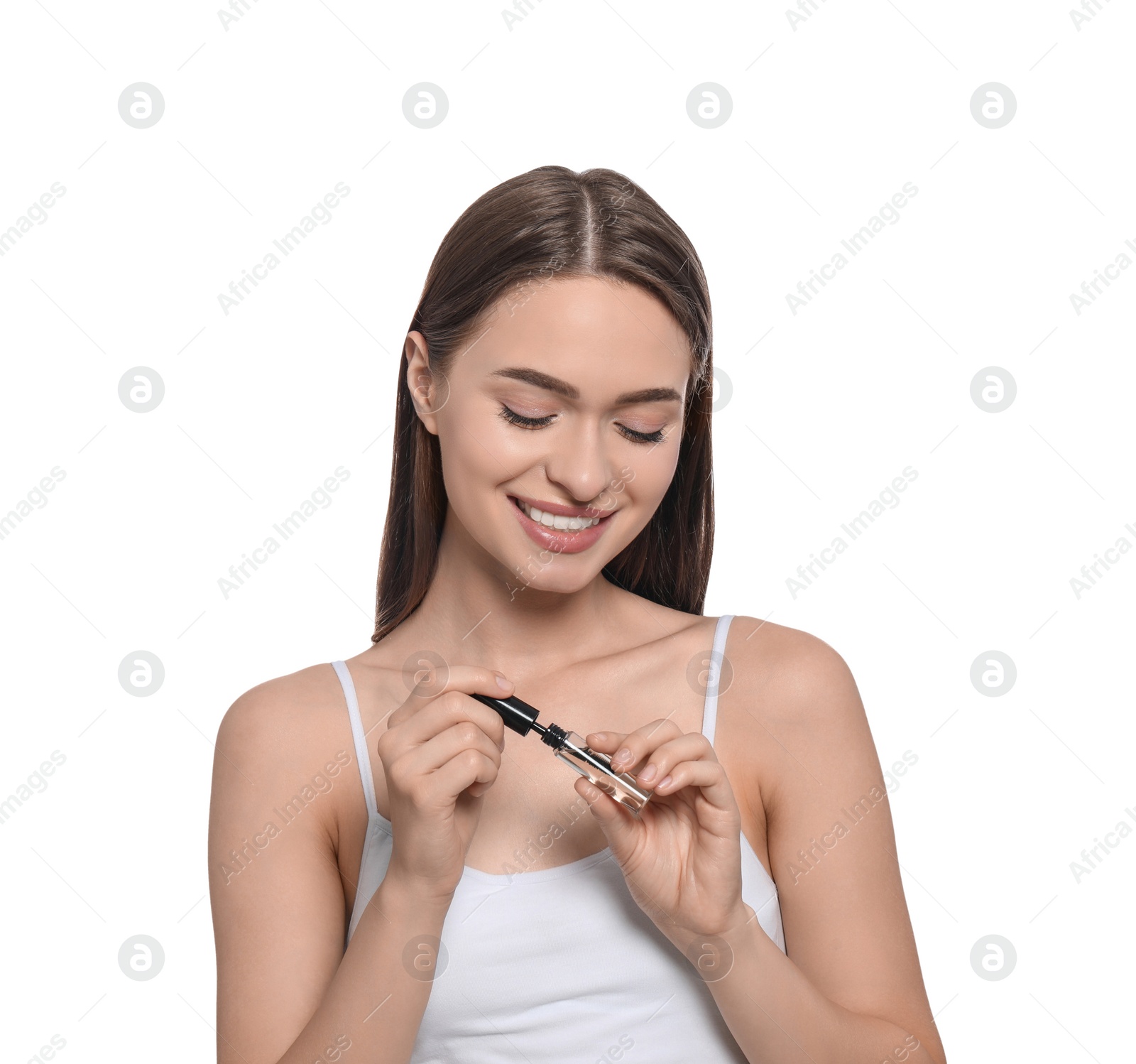 Photo of Young woman with eyelash oil on white background