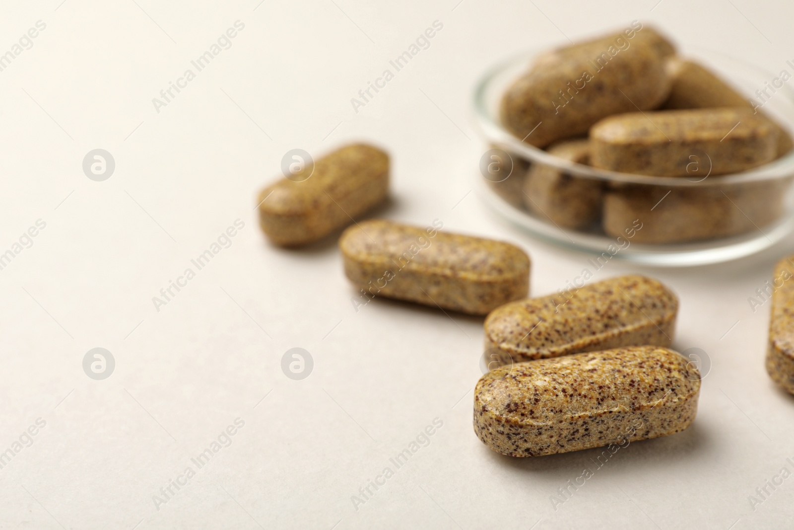 Photo of Dietary supplement pills on white background, closeup. Space for text