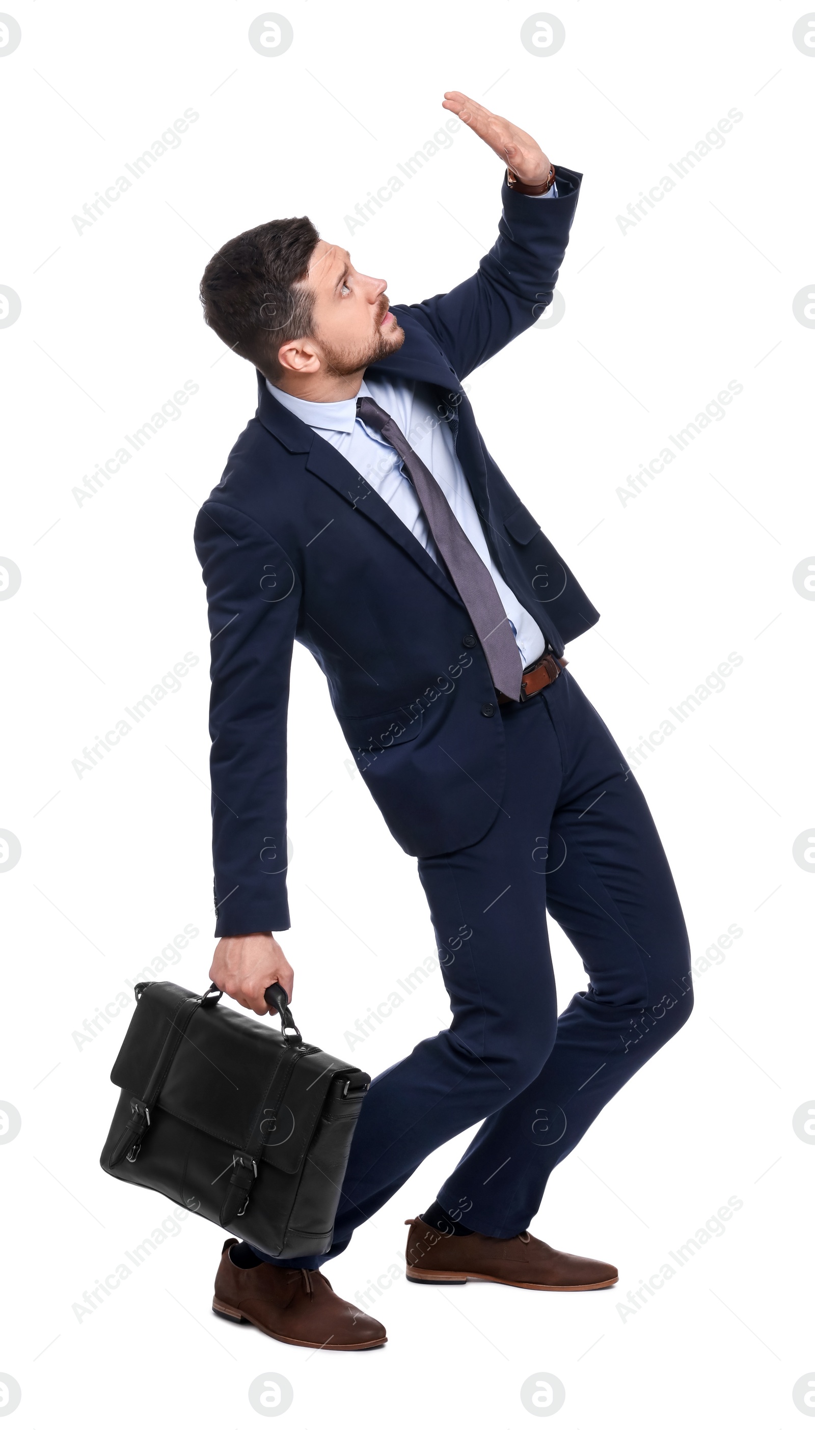 Photo of Handsome bearded businessman in suit with briefcase avoiding something on white background