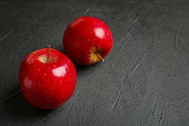 Photo of Ripe red apples on grey background