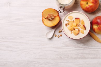 Photo of Delicious yogurt with fresh peach and granola on white wooden table, flat lay. Space for text