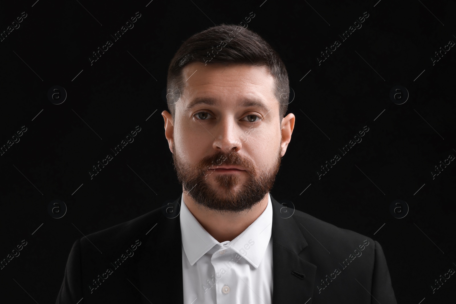 Photo of Personality concept. Portrait of handsome man on black background