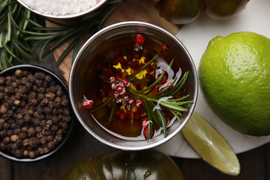 Photo of Tasty marinade and products on table, flat lay