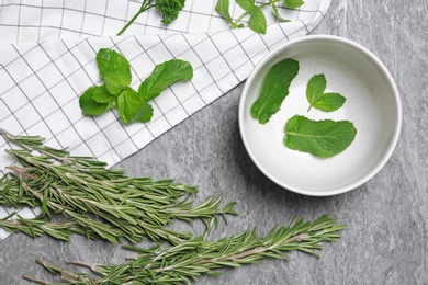 Photo of Flat lay composition with rosemary on table. Aromatic herbs