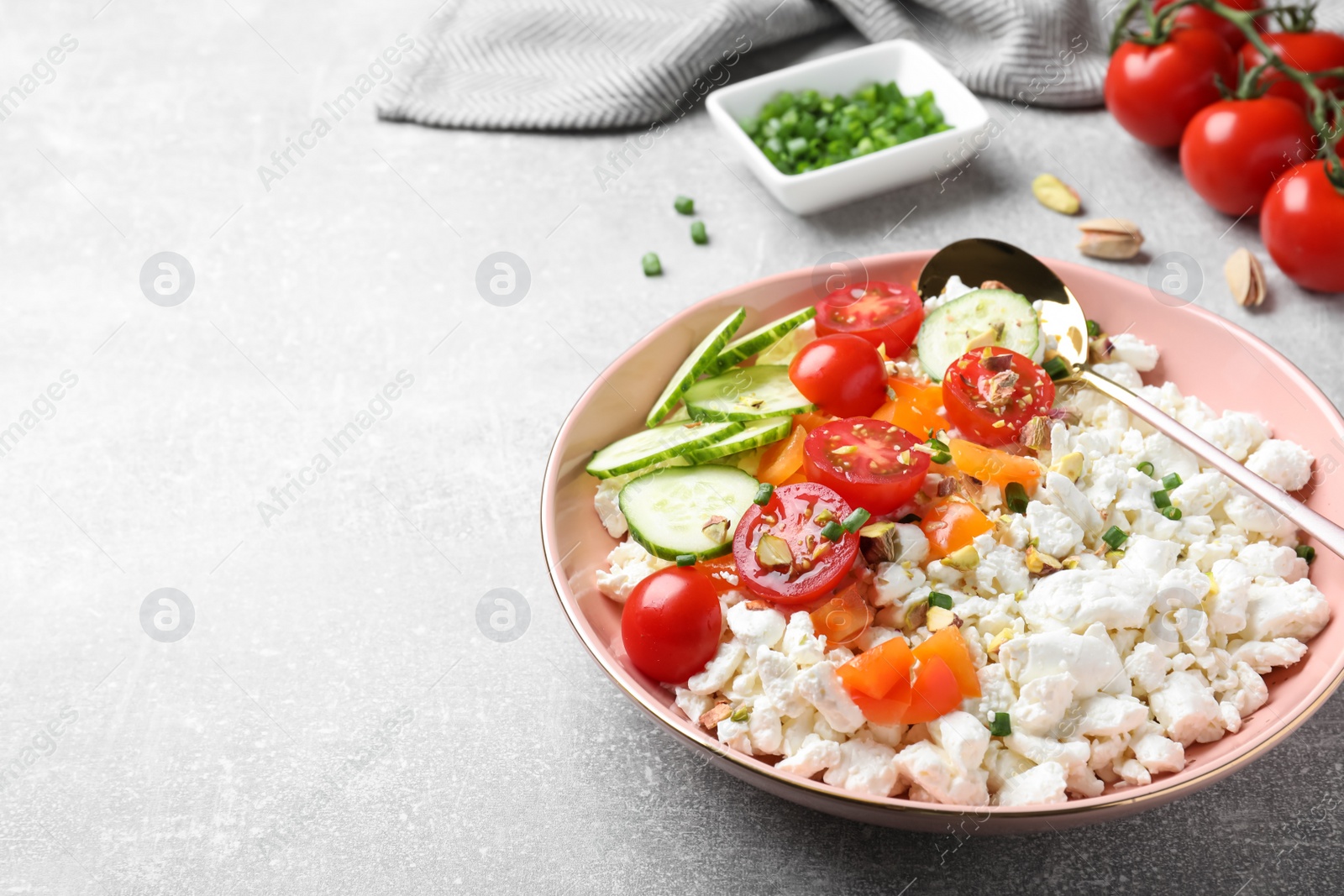 Photo of Delicious cottage cheese with vegetables served on light grey table, space for text. Tasty breakfast