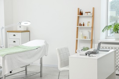 Modern interior of dermatologist's office with examination table