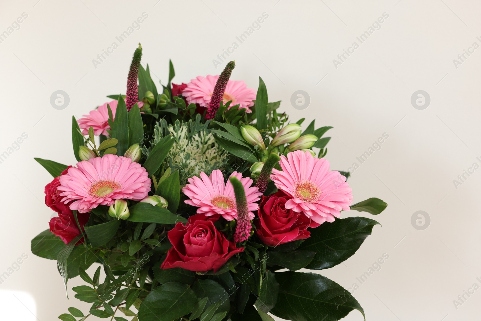 Photo of Bouquet of beautiful flowers on light background, closeup. Space for text