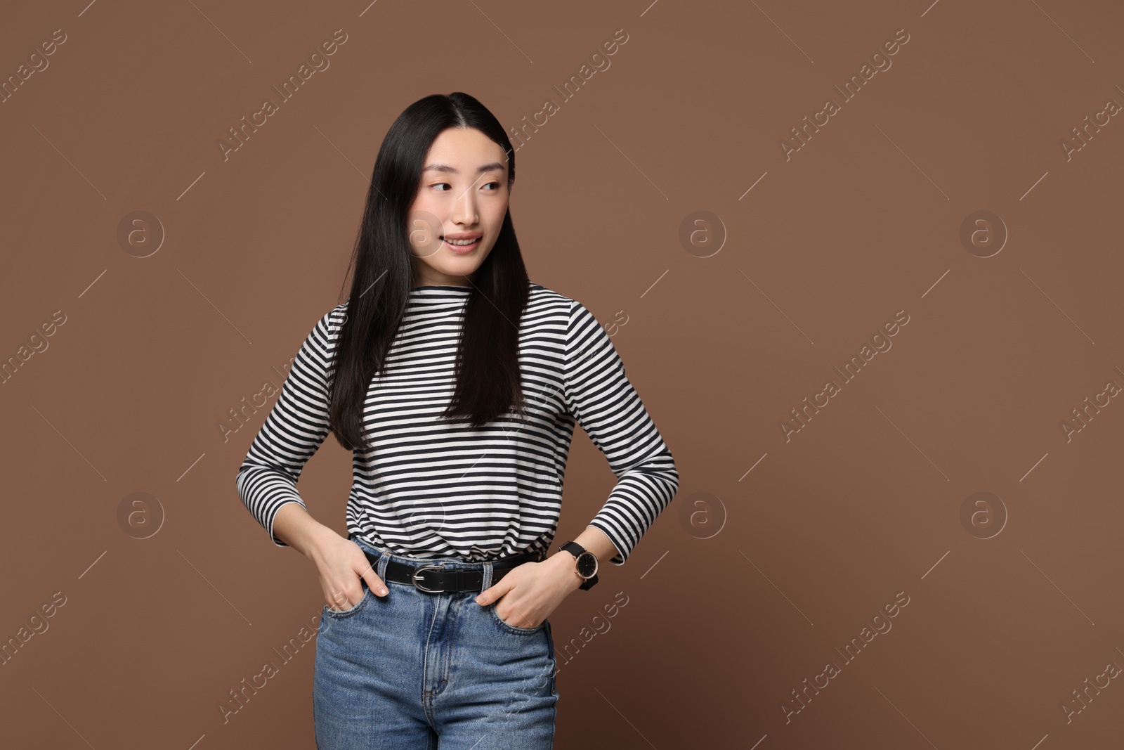 Photo of Portrait of smiling woman on brown background. Space for text