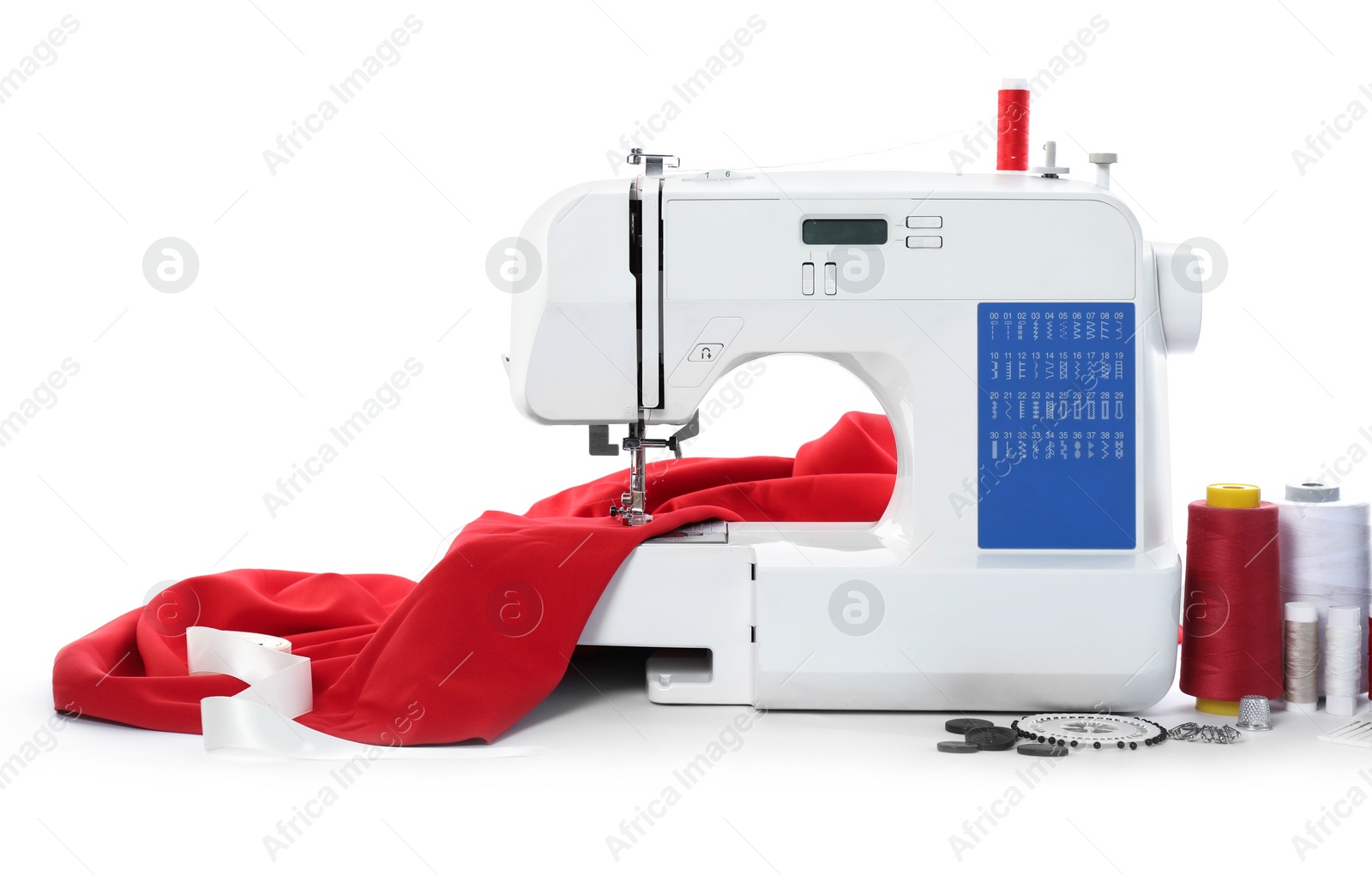 Photo of Sewing machine with fabric and craft accessories isolated on white