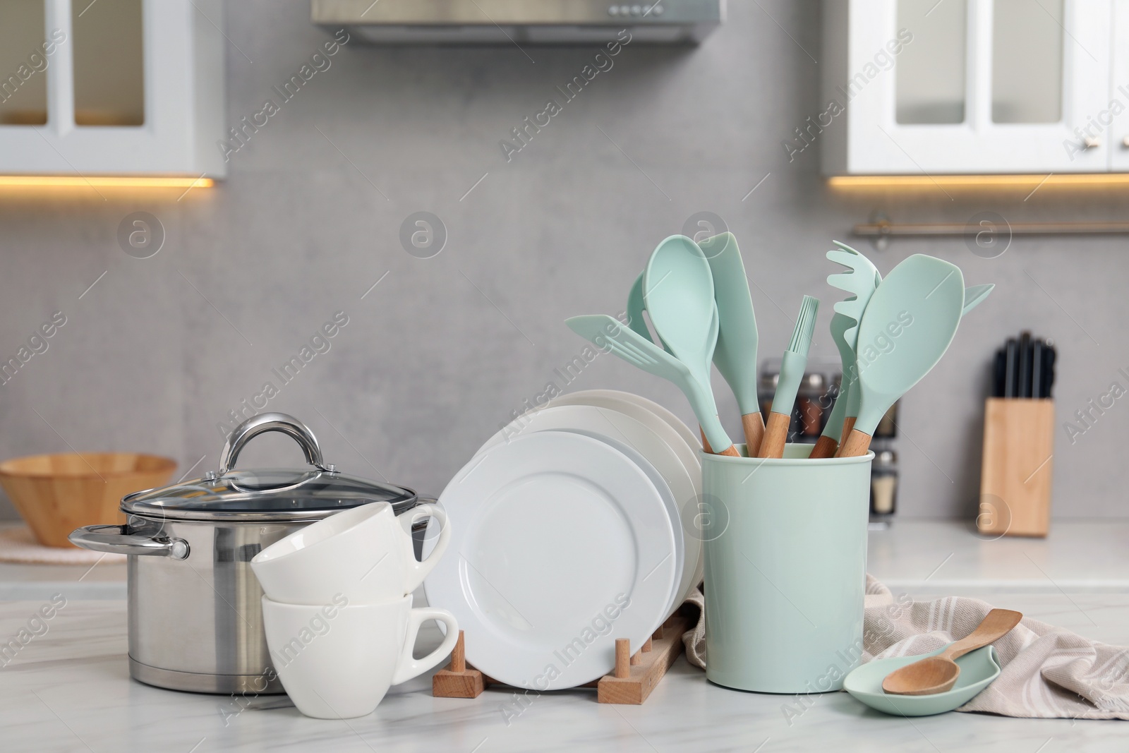 Photo of Set of different kitchenware on white table at home