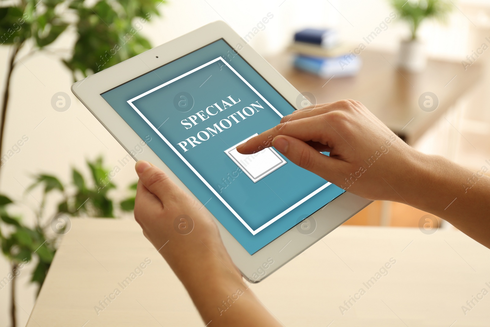 Image of Special Promotion. Young woman using tablet indoors, closeup