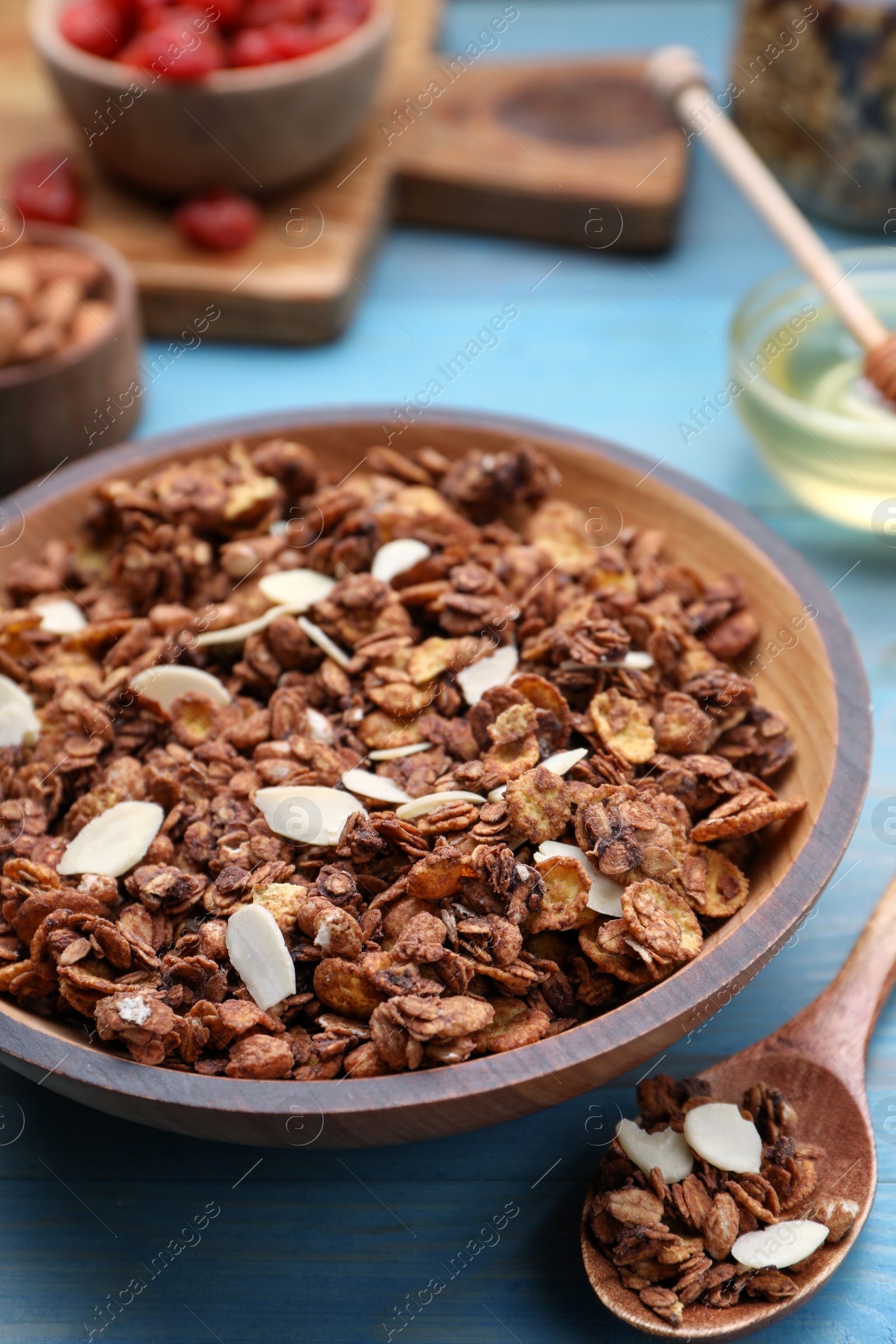 Photo of Tasty granola with nuts and dry fruits on light blue wooden table, closeup