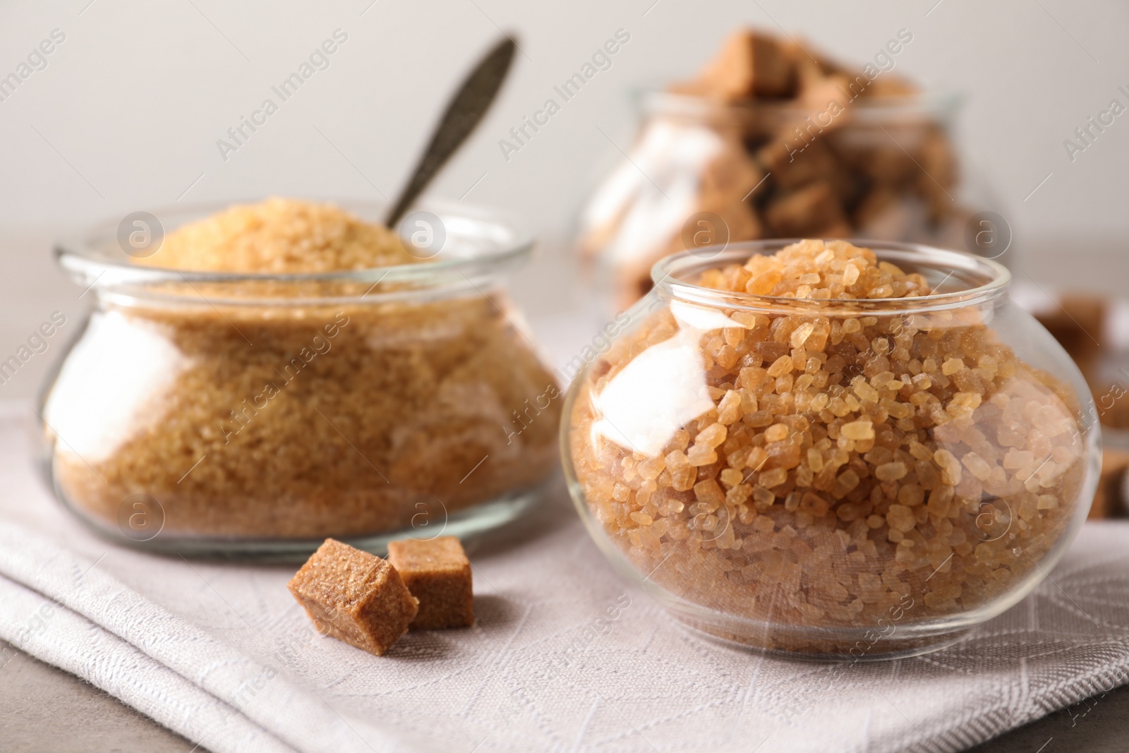 Photo of Glass bowls with brown sugar on table