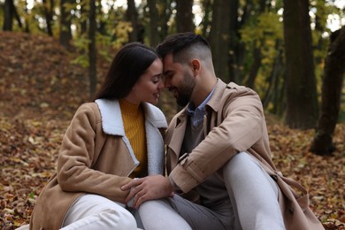 Happy young couple spending time together in autumn park